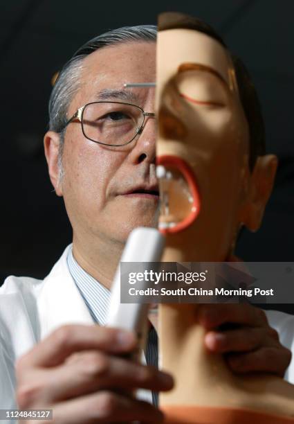 Prof. William Wei, from the Department of Surgery at the University of Hong Kong's Faculty of Medicine, holds an anti-snoring implant which is used...