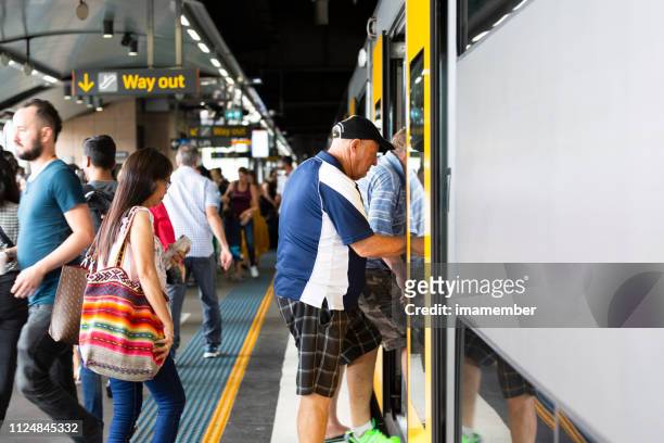 senior man boarding train, background with copy space - sydney commuter stock pictures, royalty-free photos & images