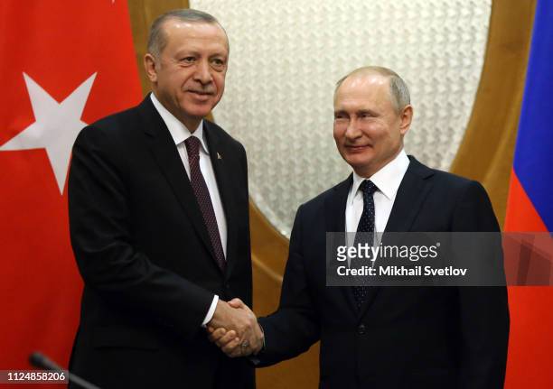 Russian President Vladimir Putin shakes hands with Turksih President Recep Tayyip Erdogan during their meeting on February 14, 2019 in Sochi, Russia....