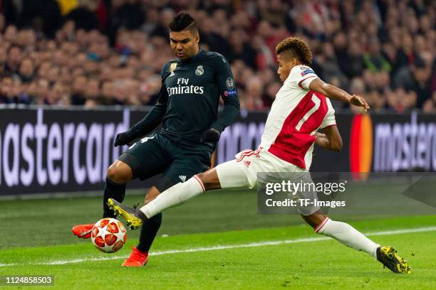 Casemiro of Real Madrid and David Neres of Ajax battle for the ball during the UEFA Champions League Round of 16 First Leg match between Ajax and...