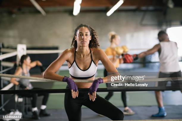 portrait of female boxer in boxing ring - boxing - women's stock pictures, royalty-free photos & images