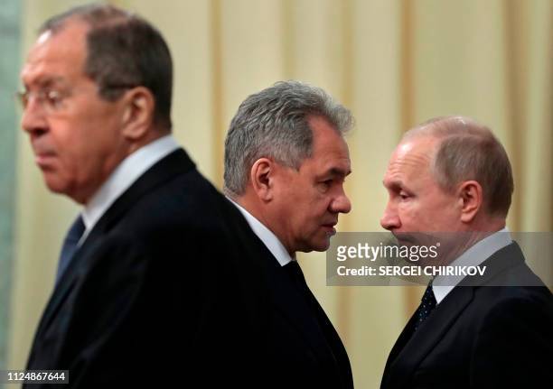 Russian President Vladimir Putin , accompanied by Defence Minister Sergei Shoigu and Foreign Minister Sergei Lavrov, waits for a meeting with his...