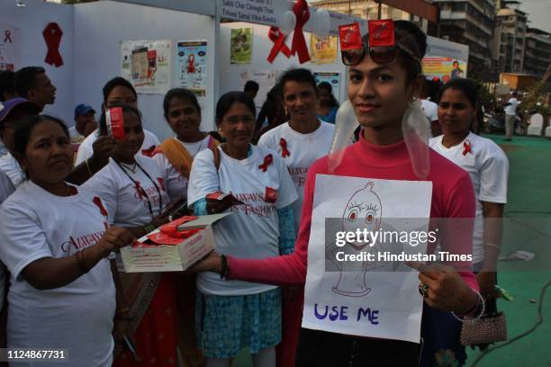 Youngsters participate in a drive to increase awareness about condoms as a contraceptive method, at Shivaji Maidan in Jambli Naka, on the occasion of...