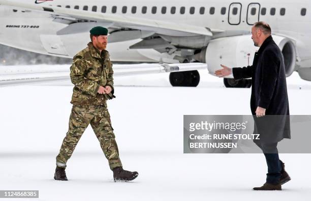 Britain's Prince Harry, Duke of Sussex, is welcomed by the ambassador of Great Britain in Norway, Richard Wood, on February 14, 2019 as he arrives at...