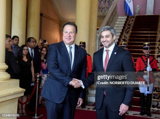 Paraguay's President Mario Abdo Benitez and Panama's President Juan Carlos Varela shake hands upon his arrival at the presidential palace in Asuncion...