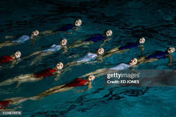 Swimmers perform in a synchronised swimming gala event celebrating late North Korean leader Kim Jong Il, in Pyongyang on February 14, 2019.