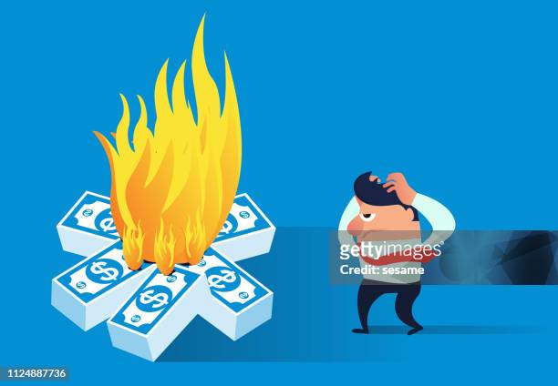 the businessman found that the money was on fire - wasting money stock illustrations