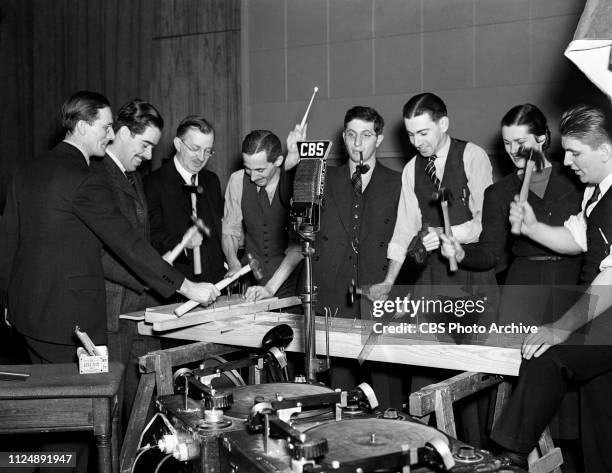 Members of CBS Radios' Columbia Workshop sound effects including figures 1, unidentified; William N. Robson, director; figure 3 unidentified; George...