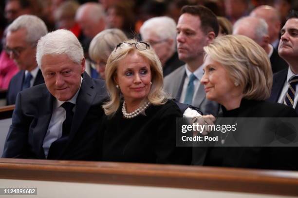 Rep. Debbie Dingell , center, talks with former U.S. President Bill Clinton and former Secretary of State Hillary Clinton during funeral services for...