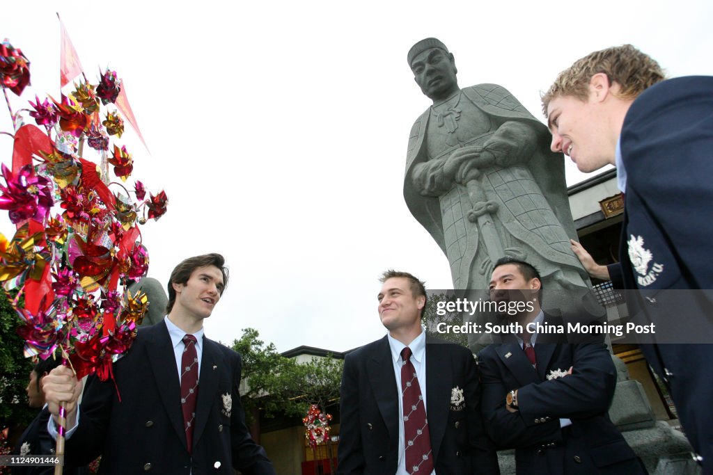Hong Kong rugby sevens team go to Che Kung Temple in Sha Tin to pray for good luck. Team player Justin Gregory holds a set of Wheels of fortune while talking with his fellow players Andrew Chambers (middle), Jeff Wong(2nd right) and Mark Wright. 24 March