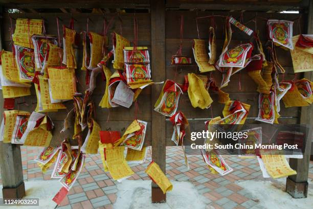 Paper offerings of wishes onto the a board near the Tai Po Wishing Tree, Tai Po, New Territories. 06 January 2006.