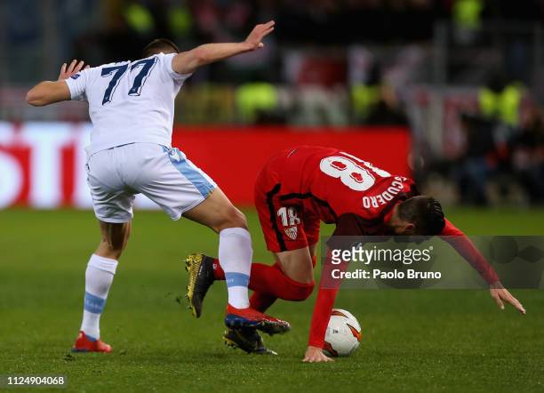 Sergio Escudero of Sevilla competes for the ball with Adam Marusic of SS Lazio during the UEFA Europa League Round of 32 first leg match between SS...