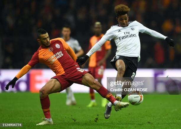 Galatasaray's Moroccan midfielder Younes Belhanda fights for the ball with Benfica's Portuguese midfielder Gedson Fernandes during the UEFA Europa...