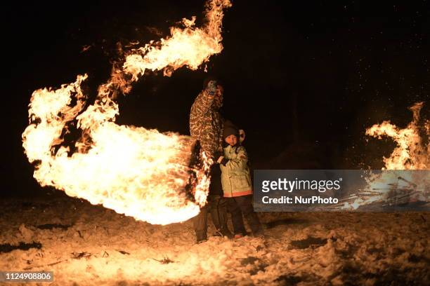 Participants perform a fire dance and create a fire ring by swing bales of burning straw during the Hiburi Kamakura Festival in Kakunodate town,...
