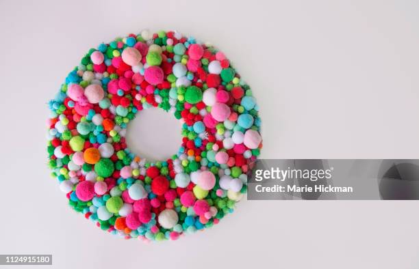christmas wreath with multi-colored pom poms. - corona di fiori composizione foto e immagini stock