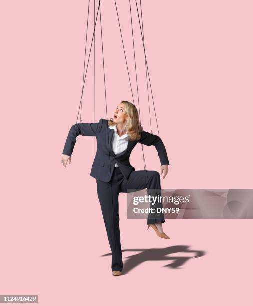 businesswoman controlled like a marionette - puppet on a string stock pictures, royalty-free photos & images