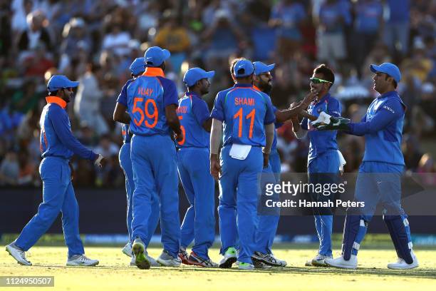 Bhuvneshwar Kumar of India celebrates the wicket of Martin Guptill of the Black Caps with Virat Kohli during game two of the One Day International...