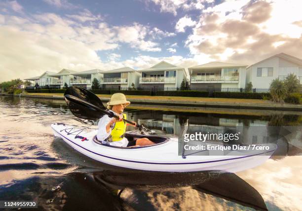 one woman kayaking on a lake - oar stock pictures, royalty-free photos & images