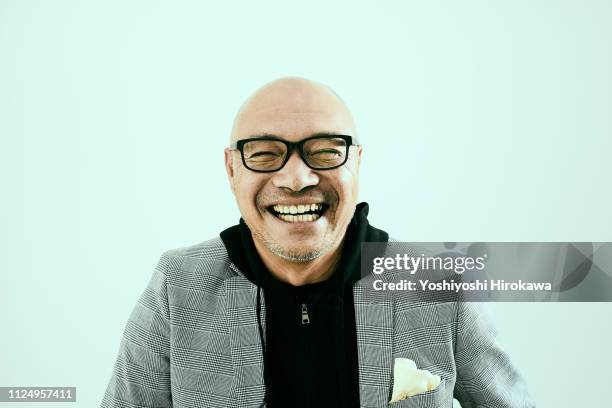 portrait of smiling senior businessman in office - intelligence agency stock pictures, royalty-free photos & images