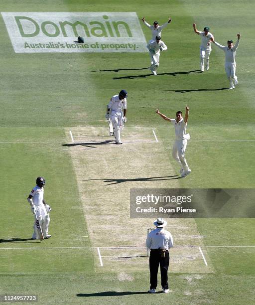 Pat Cummins of Australia celebrates after taking the wicket of Lahiru Thirimanne of Sri Lanka during day three of the First Test match between...