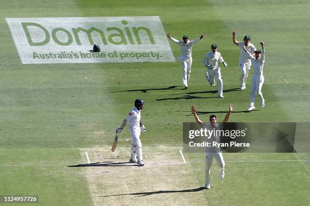 Pat Cummins of Australia celebrates after taking the wicket of Lahiru Thirimanne of Sri Lanka during day three of the First Test match between...