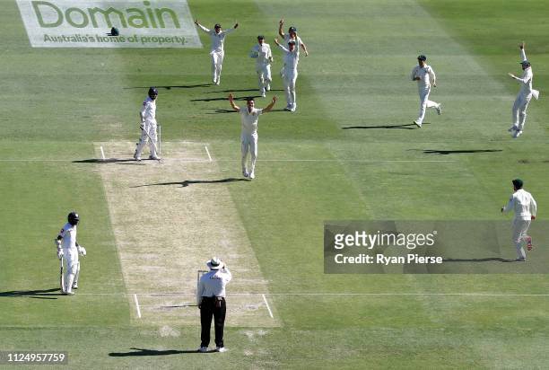 Pat Cummins of Australia celebrates after taking the wicket of Lahiru Thirimanne of Sri Lanka during day three of the First Test match between...