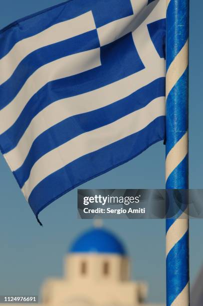 greek flag with blue domed church - flagpole sitting stockfoto's en -beelden