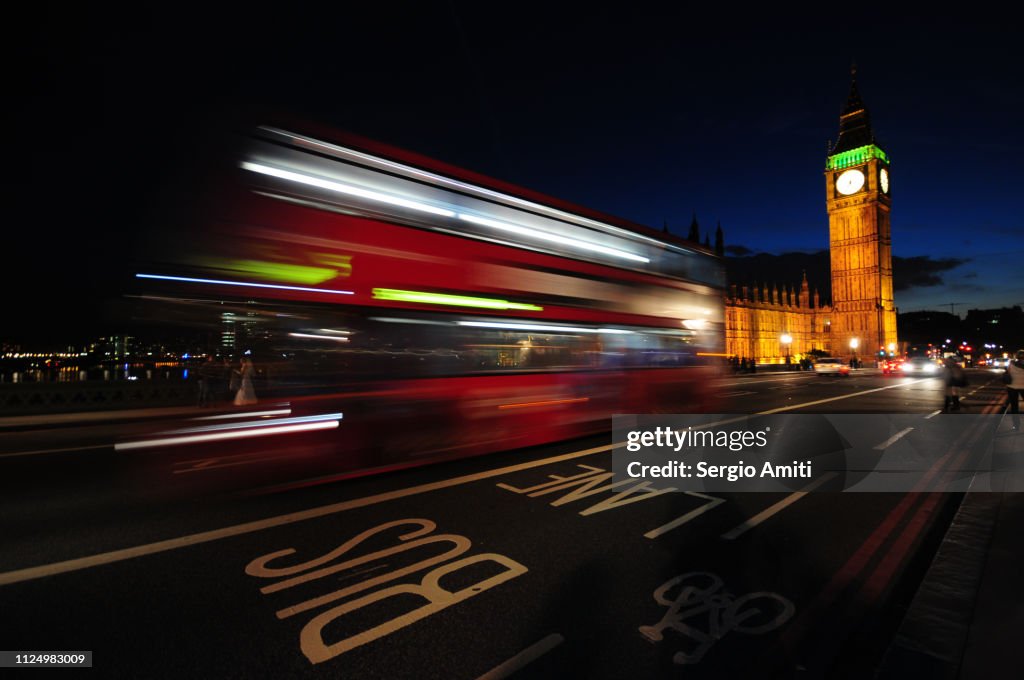 Red bus light trails by Big Ben