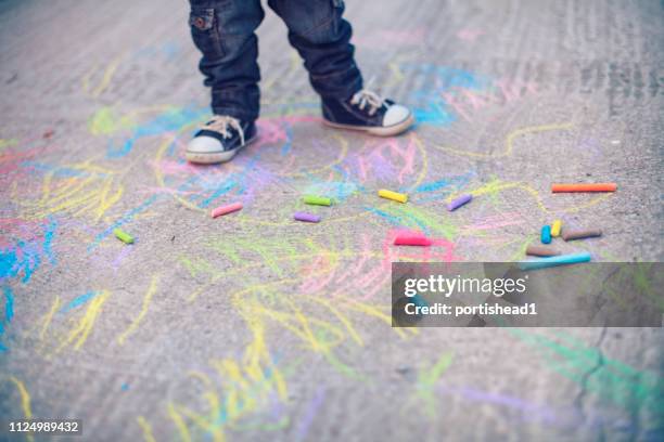 little boy legs and sidewalk chalks - sidewalk chalk drawing stock pictures, royalty-free photos & images