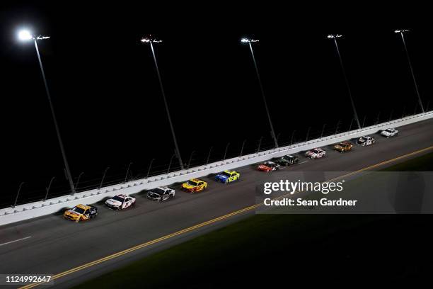 Clint Bowyer, driver of the Rush Truck Centers/Mobil 1 Ford, leads a pack of cars during the Monster Energy NASCAR Cup Series Gander RV Duel At...