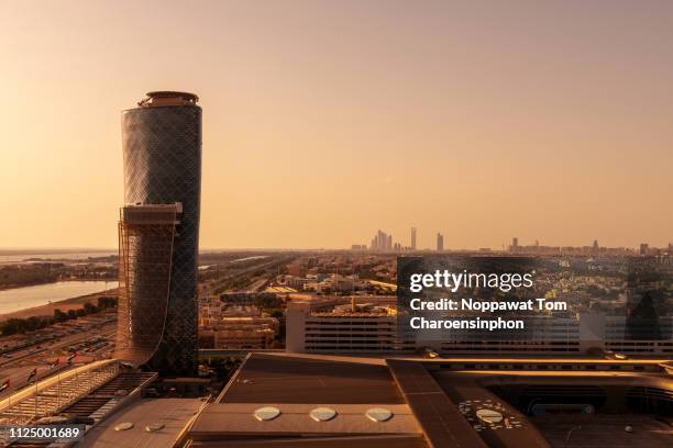 abu dhabi cityscape at dusk, united arab emirates - abu dhabi buildings stock pictures, royalty-free photos & images