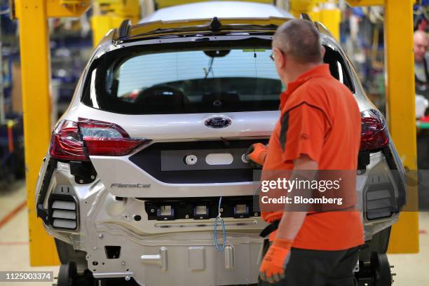 An employee closes the boot on a Ford Fiesta automobile on the assembly line at the Ford Motor Co. Factory in Cologne, Germany, on Wednesday, Feb....