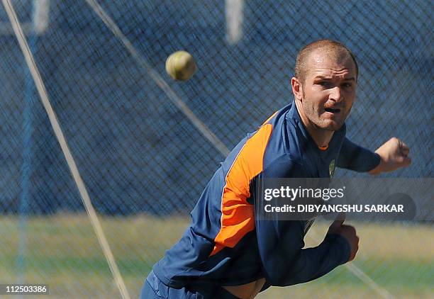 Australian cricketer Jason Krejza bowls into the nets during a training session at the National Cricket Acdemy in Bangalore on February 12, 2011. The...