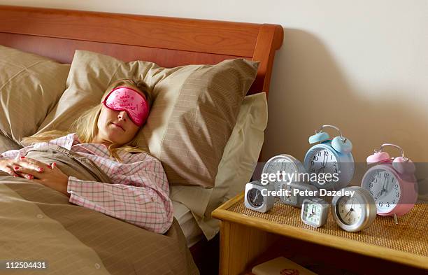 young woman with problem waking up - wecker stock-fotos und bilder