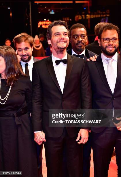 Brazilian director Wagner Moura and members of the casting crew pose on the red carpet before the premiere of the film "Marighella" screened out of...