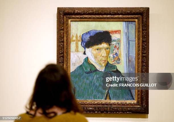Visitor looks the painting "Self Portrait with Bandaged Ear " by Dutch painter Vincent Van Gogh during the press visit of the exhibition "The...