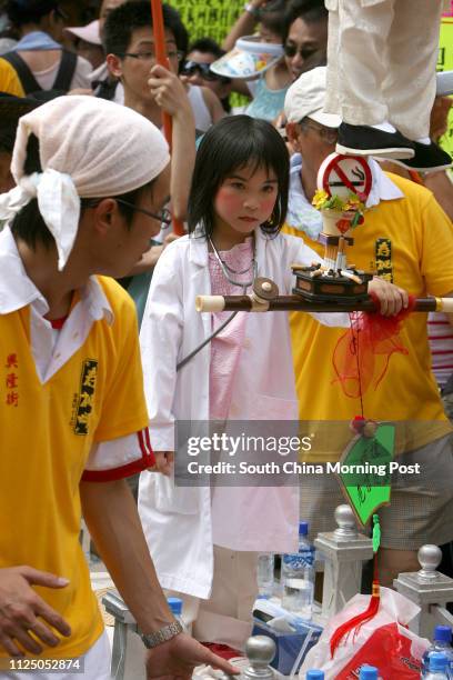 Youngster dresses as mythological figures to promote not smoking, and held aloft on hidden rods, appears to float above the heads of the crowd at The...