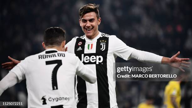 Juventus' Portuguese forward Cristiano Ronaldo celebrates with Juventus' Argentine forward Paulo Dybala after scoring during the Italian Serie A...