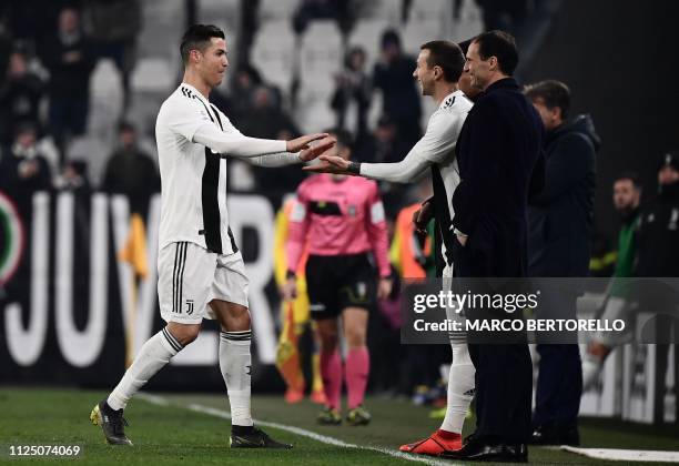 Juventus' Portuguese forward Cristiano Ronaldo taps hands as he is replaced by Juventus' Italian forward Federico Bernardeschi as Juventus' Italian...