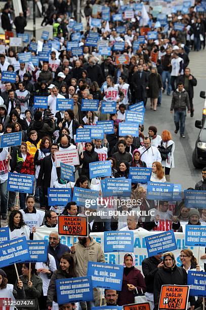 Doctors, nurses and students shout slogans and hold banners during a demonstration against the health care system in Istanbul on April 19, 2011....