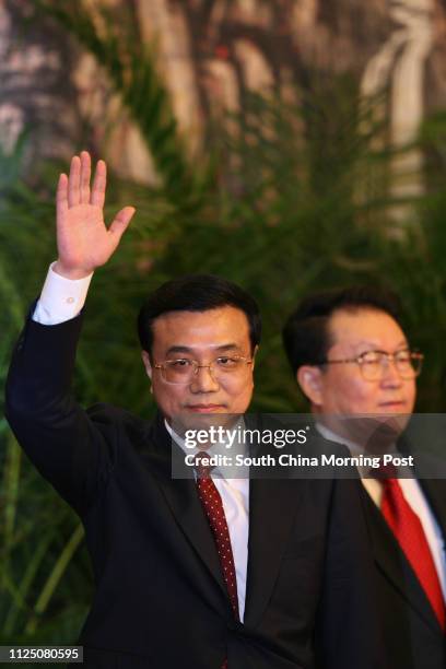 Chinese communist party's new leadership team Li Keqing waves to media at the Great Hall of the People in Beijing. And Li Changchun. 22 October 2007