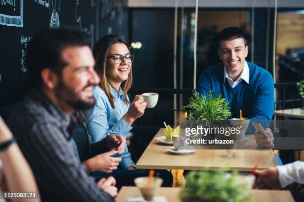 old friends in cafe enjoying in reunion. - casual clothing stock pictures, royalty-free photos & images