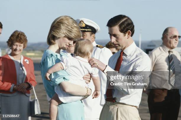 Diana, Princess of Wales carrying Prince William beside Prince Charles after their arrival at Alice Springs airport for their tour of Australia, 20...