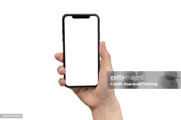 close up hand hold phone isolated on white, mock-up smartphone white color blank screen - hand stock-fotos und bilder