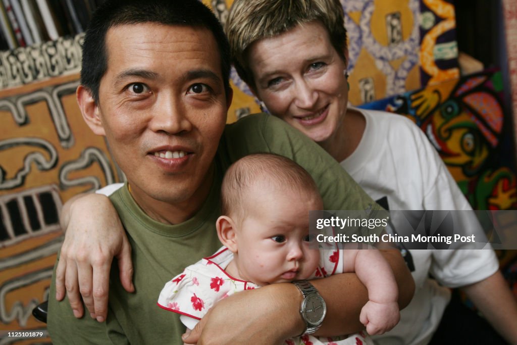 Portrait of Burmese artist Htein Lin with his wife Vicky Bowman and their baby Aurora. Karen Weber Gallery, Central. 21 MARCH 2008