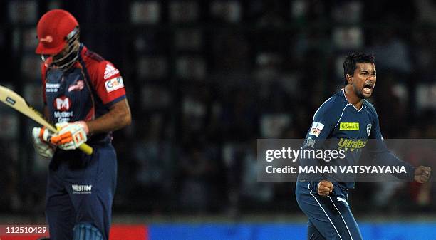 Deccan Chargers spinner Pragyan Ojha celebrates after taking the wicket of Delhi Daredevils batsman Irfan Pathan during the IPL Twenty20 match...