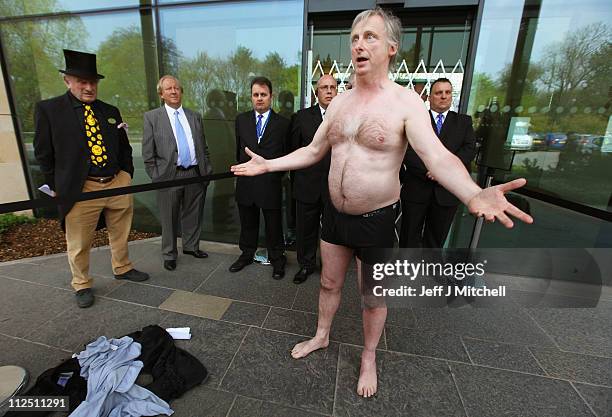 Kit Fraser from Inverness removes his clothes in protests outside the Royal Bank of Scotland annual meeting on April 19, 2011 in Edinburgh....