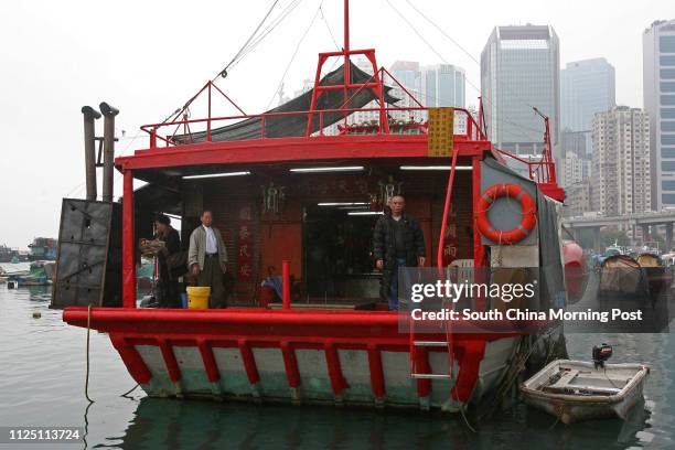 Poon Kam-tim member of the executive committee of the floating Tin Hau temple pictured with chief of the temple Leung Yau in Causeway Bay Typhoon...