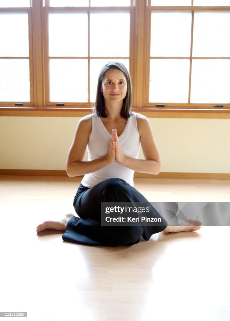 One Women, smiling, in a yoga pose