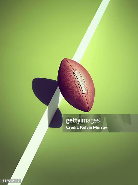 sports shadow - american football ball studio stock pictures, royalty-free photos & images